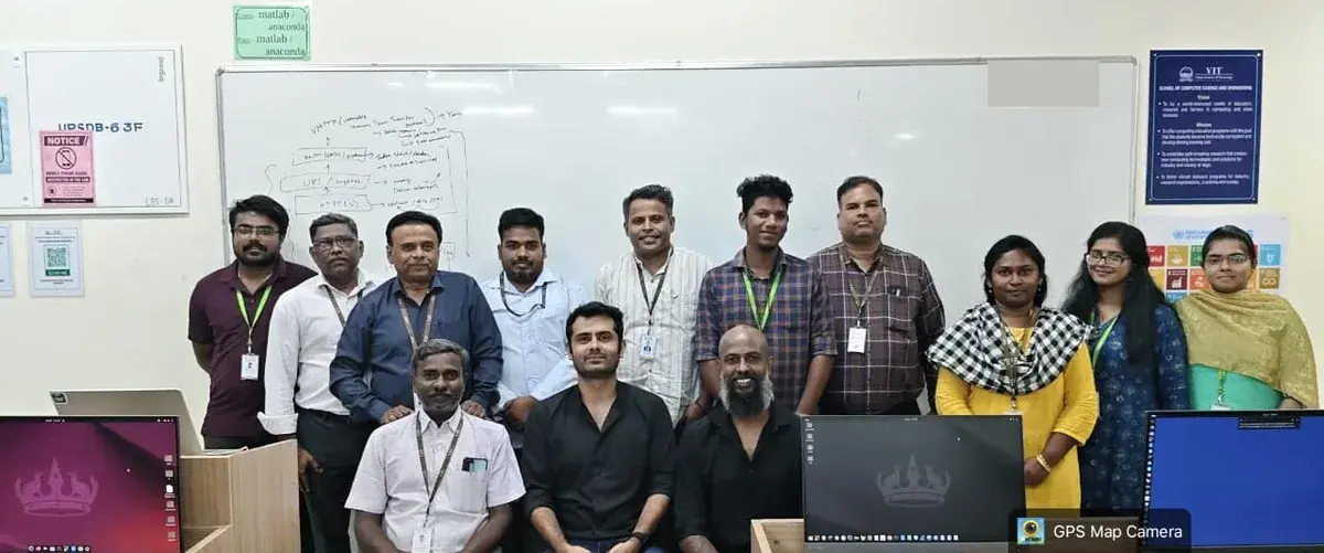 Faculty and facilitators posing together in the computer classroom