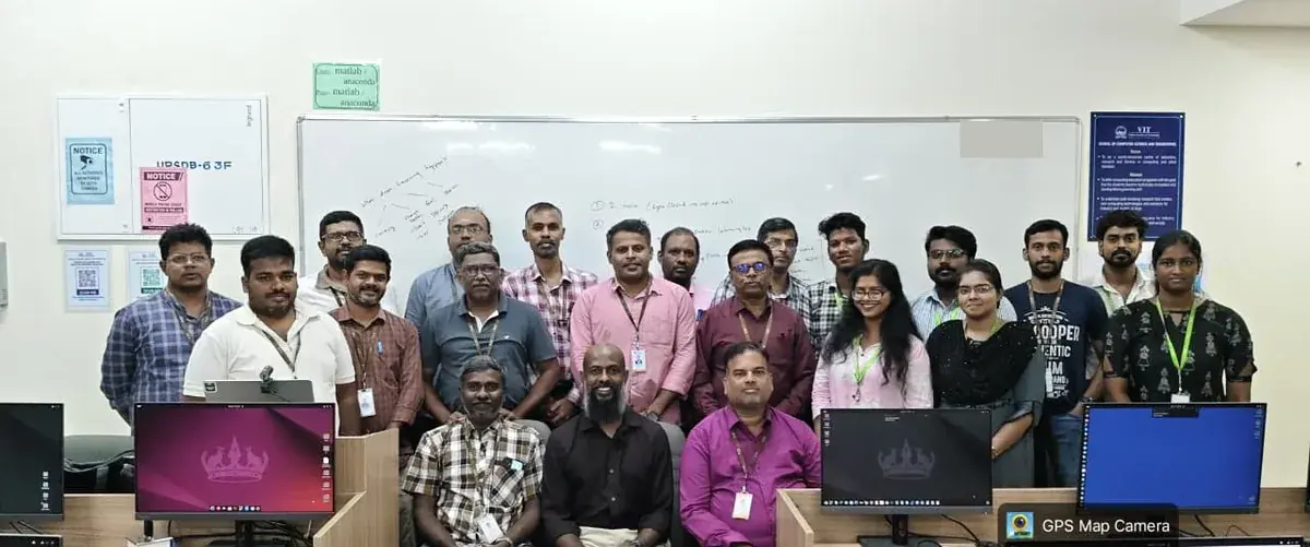 Faculty and facilitator gathered for a group photograph in the classroom on Day 3