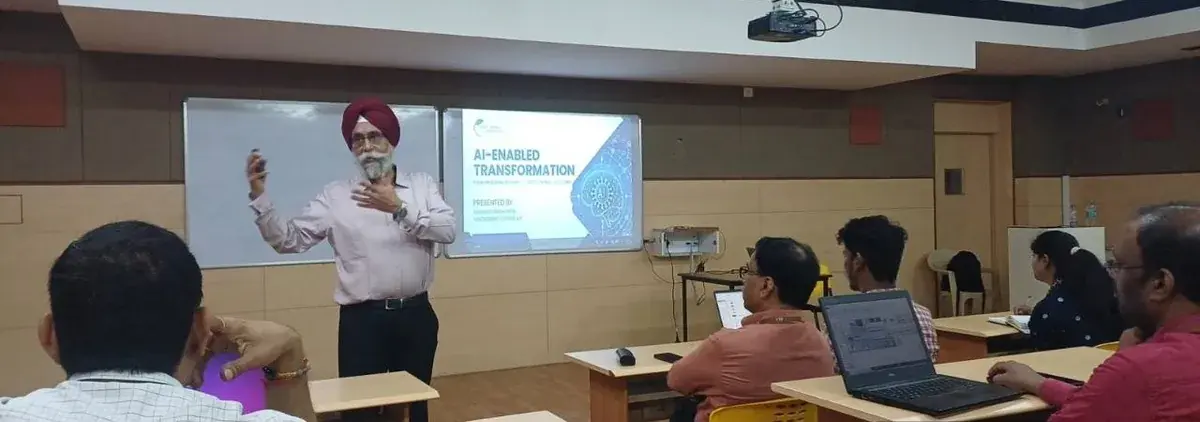 Barinder Sethi gesturing during the final-day session while faculty follow the presentation